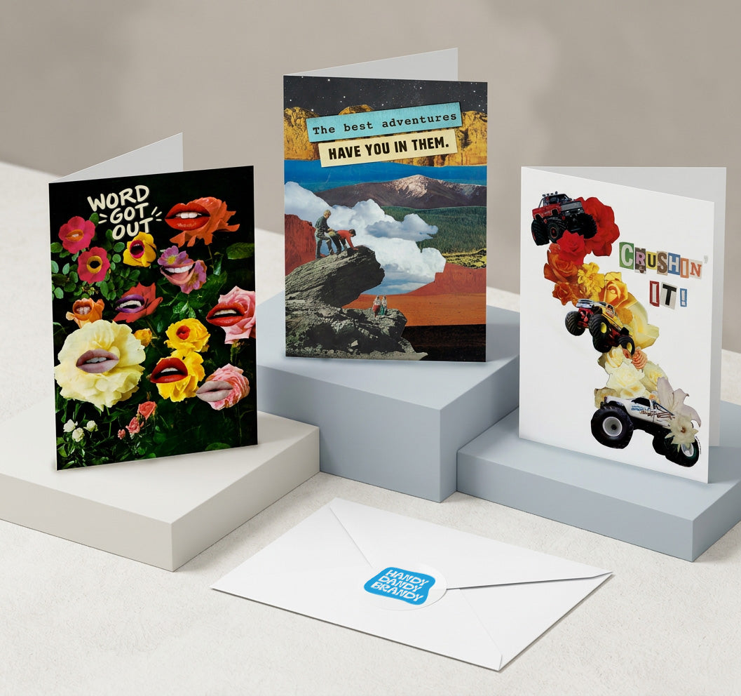 Three illustrated greeting cards and a white envelope displayed on light gray pedestals. The cards feature colorful abstract floral and landscape artwork with text including 'WORD GOT TO GO OUT,' 'The best adventures HAVE YOU IN THEM.