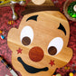 Wooden pizza peel board with cartoon face design, natural light-brown finish and black accents