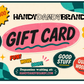 HandyDandyBrandy gift card design with a cream background, teal checkered corner accents, a yellow starburst reading '$25-$300', and large pink 'GIFT CARD' text. Decorative stickers include a smiley face, flower, stars, and phrases like 'FUN! WOOD! GOODS!' and 'Dopamine waiting at: HANDYDANDYBRANDY.