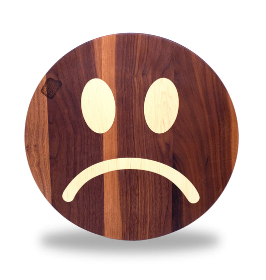 sad face cutting board made of walnut